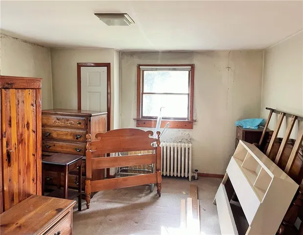 a bedroom with furniture and a window