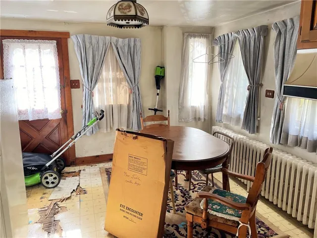 a dining room with furniture and a floor to ceiling window