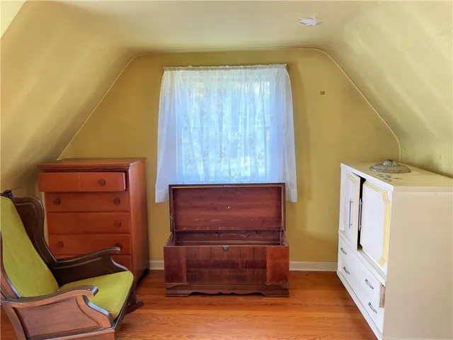 a view of room with furniture and wooden floor