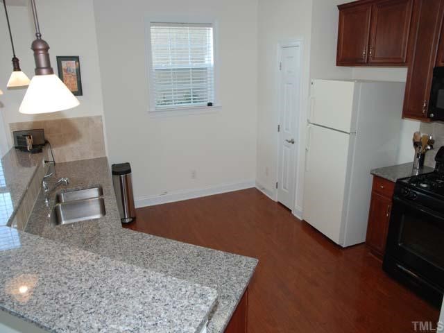 10511 Rosegate Court, Unit 6 Raleigh, NC 27617 - Photo 2 of 11 a kitchen with wooden floor and a sink