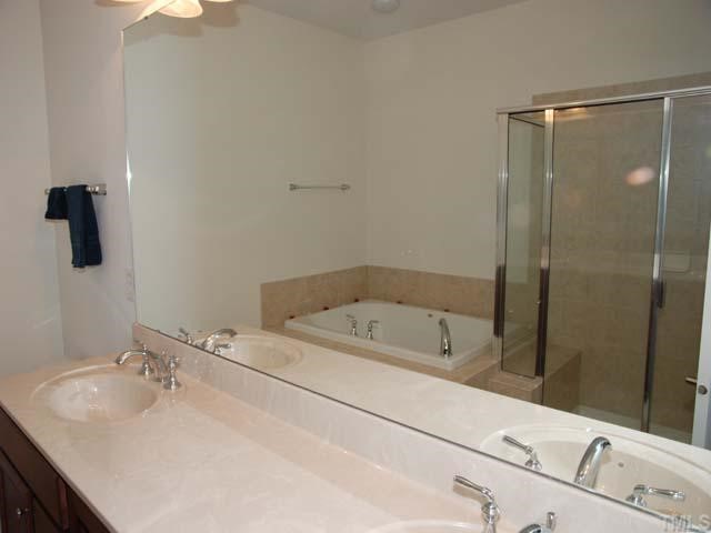 10511 Rosegate Court, Unit 6 Raleigh, NC 27617 - Photo 6 of 11 a bathroom with a tub sink and mirror