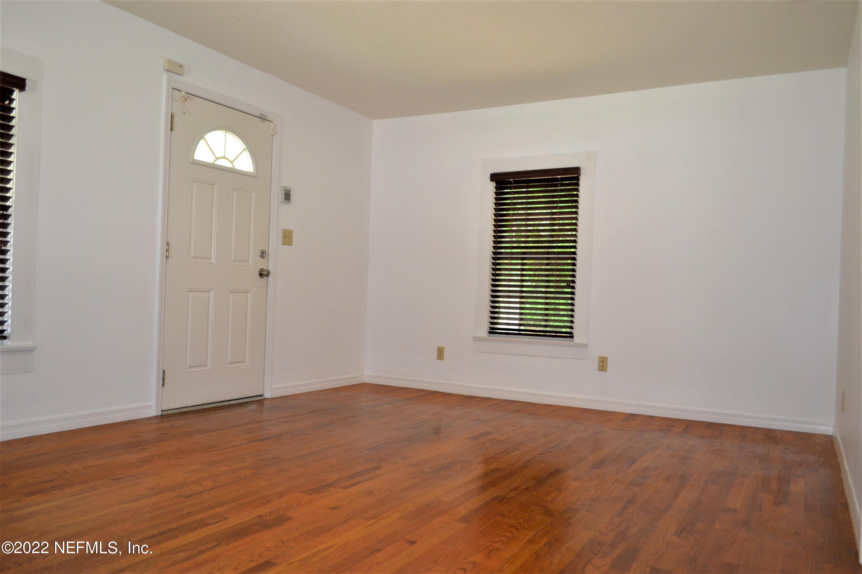4051 Spring Glen Road Jacksonville, FL 32207 - Photo 5 of 43 a view of an empty room with wooden floor and a window