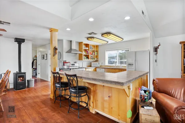 a living room with stainless steel appliances kitchen island granite countertop furniture and a dining table