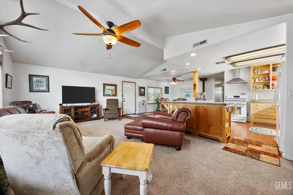 a living room with furniture a flat screen tv and a window