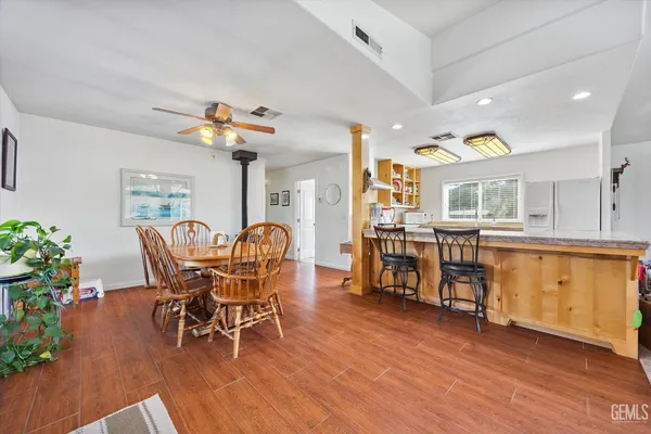 a view of a dining room with furniture and wooden floor