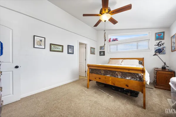 a bedroom with bed and a chandelier