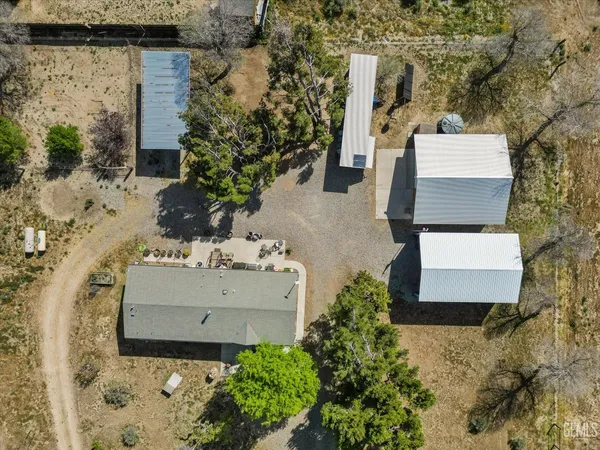 an aerial view of a house with a yard