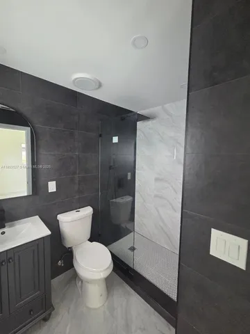 an empty refrigerator freezer a stove sitting inside of a kitchen