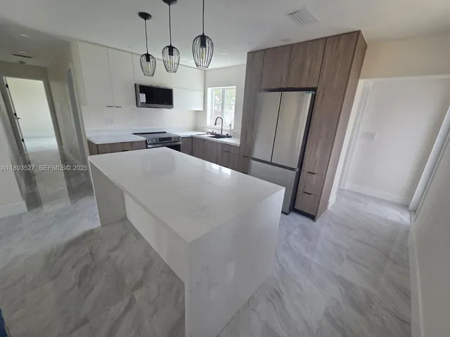 a kitchen with stainless steel appliances a refrigerator and a sink