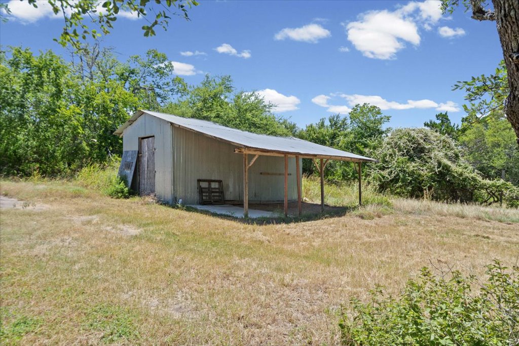 555 Harmon Hills Road, Unit A Dripping Springs, TX 78620 - Photo 27 of 29 A rustic barn provides ample storage and shelter in this verdant, spacious yard.