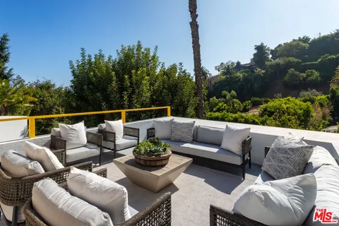 a balcony with furniture and city view