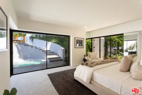a bedroom with a large bed and a large window