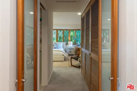 a view of a hallway with furniture and front door