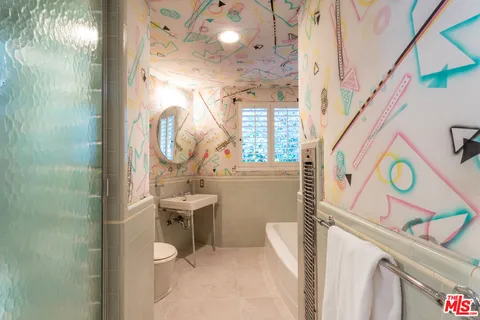a bathroom with a sink a mirror and a toilet