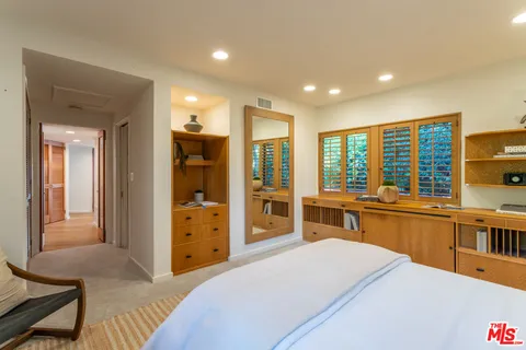 a large bedroom with a large bed and a large window