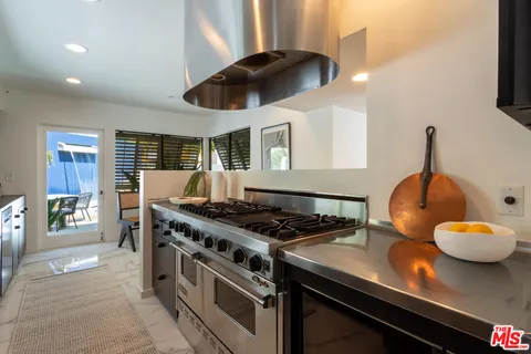 a kitchen with a stove and a wooden floors
