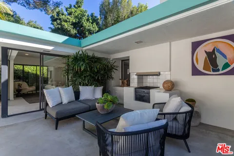 a living room with furniture and a potted plant