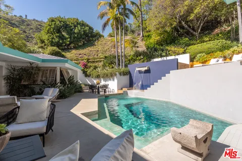 a view of backyard of house with outdoor seating