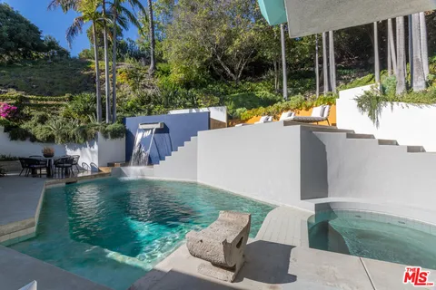 a view of backyard with swimming pool and outdoor seating