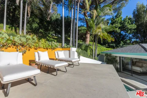 a backyard of a house with table and chairs