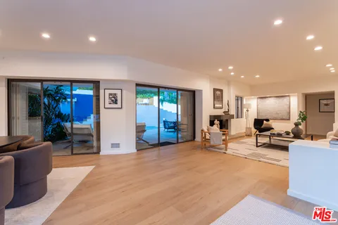 a living room with furniture and a floor to ceiling window
