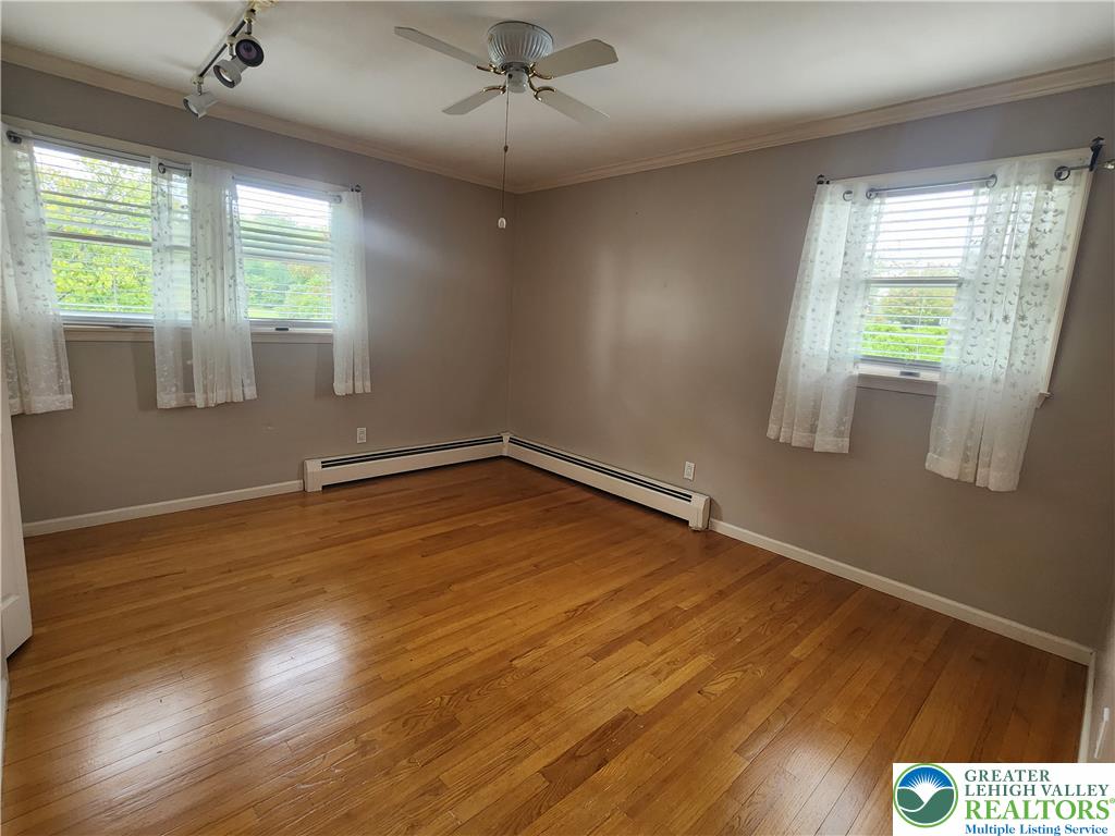 1480 Teels Road Pen Argyl, PA 18072 - Photo 14 of 18 Polished hardwood floors and classic crown molding anchor this versatile space.