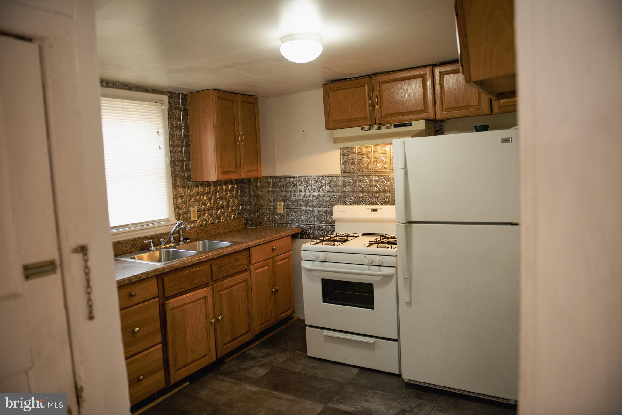 9 Hamilton Street New Castle, DE 19720 - Photo 11 of 20 a kitchen with a stove sink and refrigerator