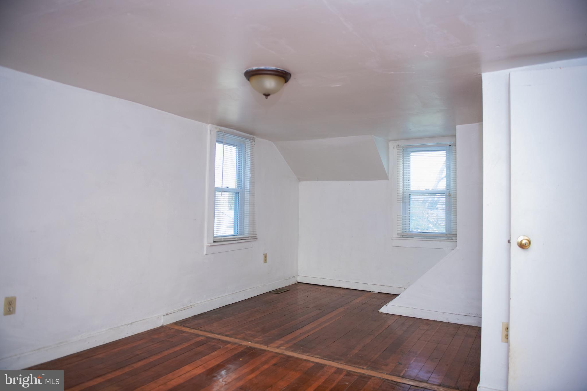 9 Hamilton Street New Castle, DE 19720 - Photo 18 of 20 an empty room with wooden floor and windows