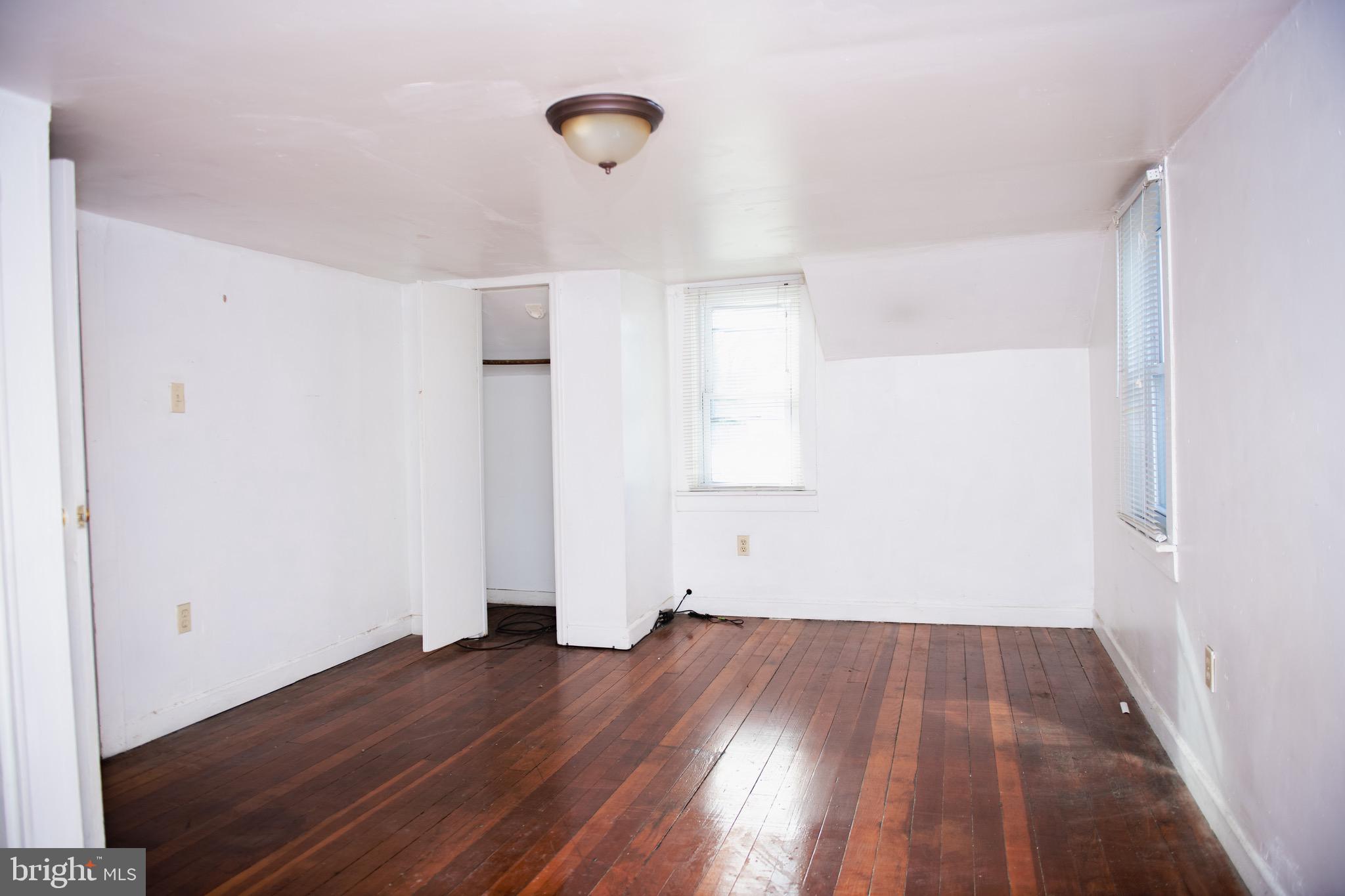 9 Hamilton Street New Castle, DE 19720 - Photo 19 of 20 an empty room with wooden floor and windows