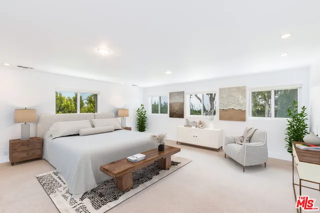 a bedroom with a large bed and a couch