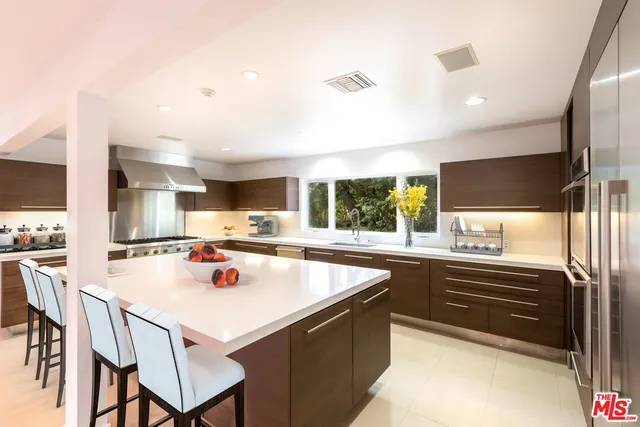 a kitchen with a stove a sink and a refrigerator