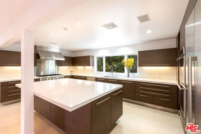 a kitchen with counter top space and stainless steel appliances