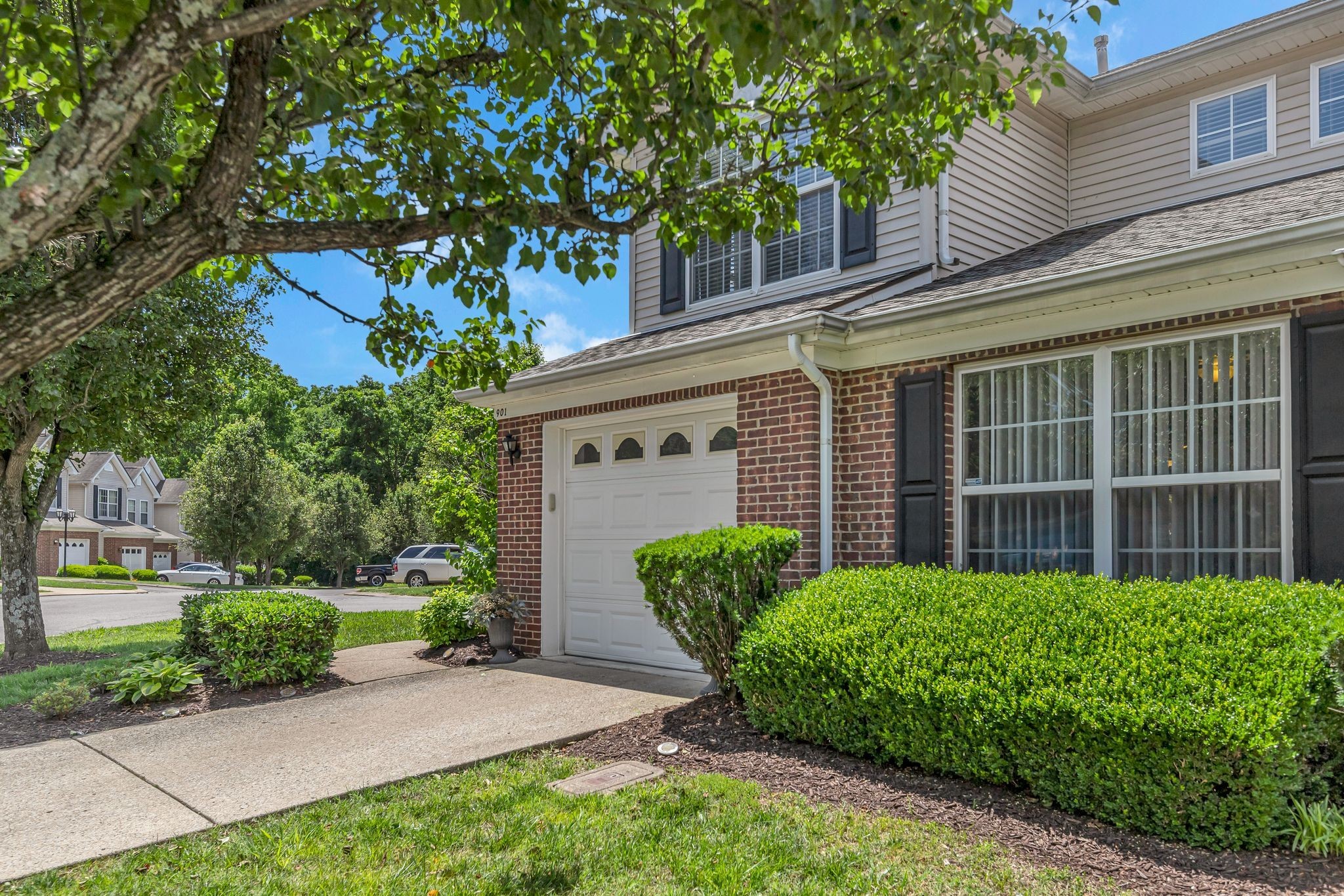a front view of a house with garden