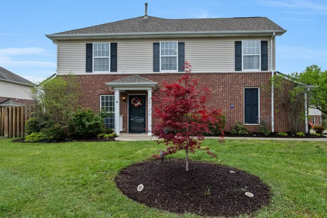 a front view of a house with a garden