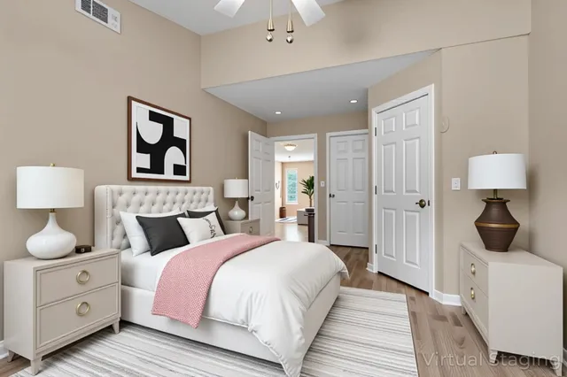 a bedroom with a bed and a painting on the wall