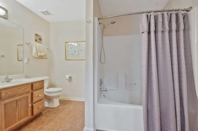 a bathroom with a shower a toilet and sink