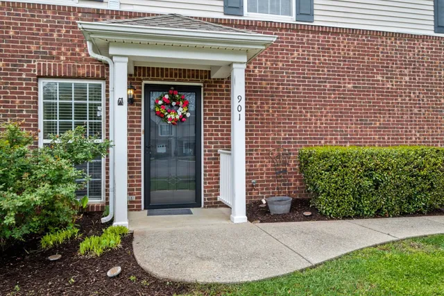 a view of a door of a house with potted plants