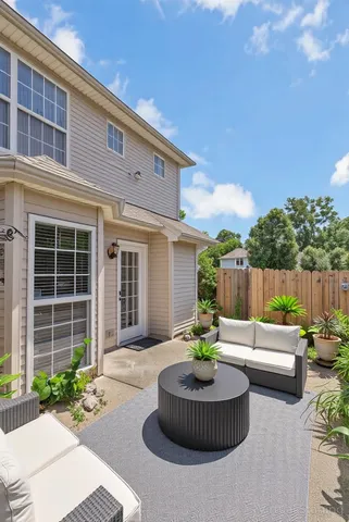 a house view with a sitting space garden and patio
