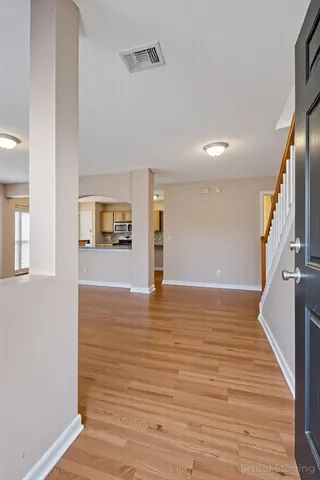a view of a water heater room with wooden floor