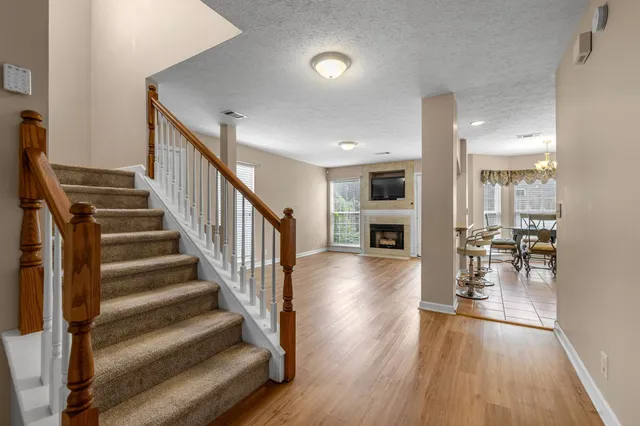 a view of entryway and hall with wooden floor