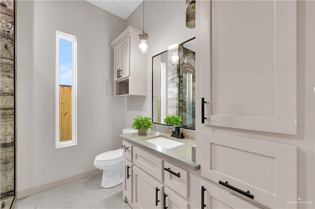 608 Spring Drive Alton, TX 78573 - Photo 15 of 32 Full bathroom with vanity and a shower with shower door