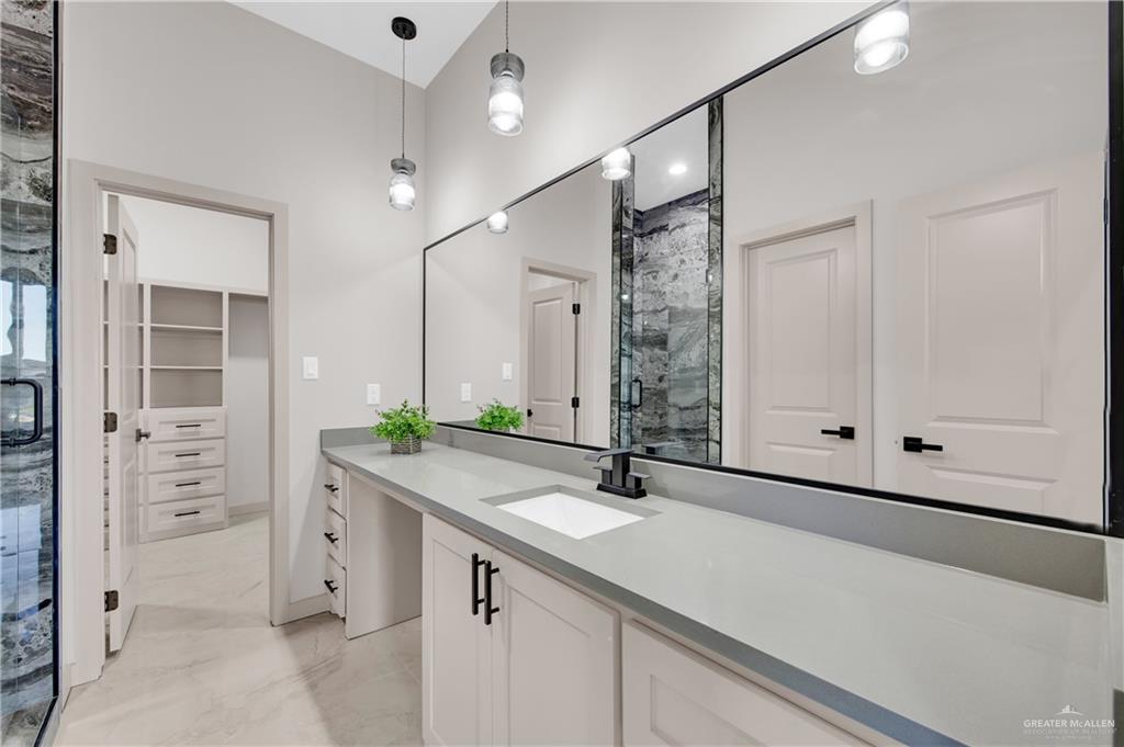 608 Spring Drive Alton, TX 78573 - Photo 20 of 32 Bathroom with vanity, a marble finish shower, and light marble finish flooring