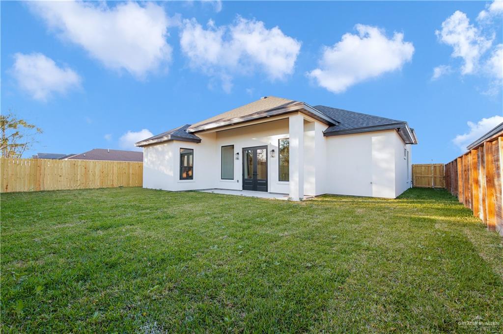 608 Spring Drive Alton, TX 78573 - Photo 23 of 32 Back of house with french doors, stucco siding, a patio, and a fenced backyard