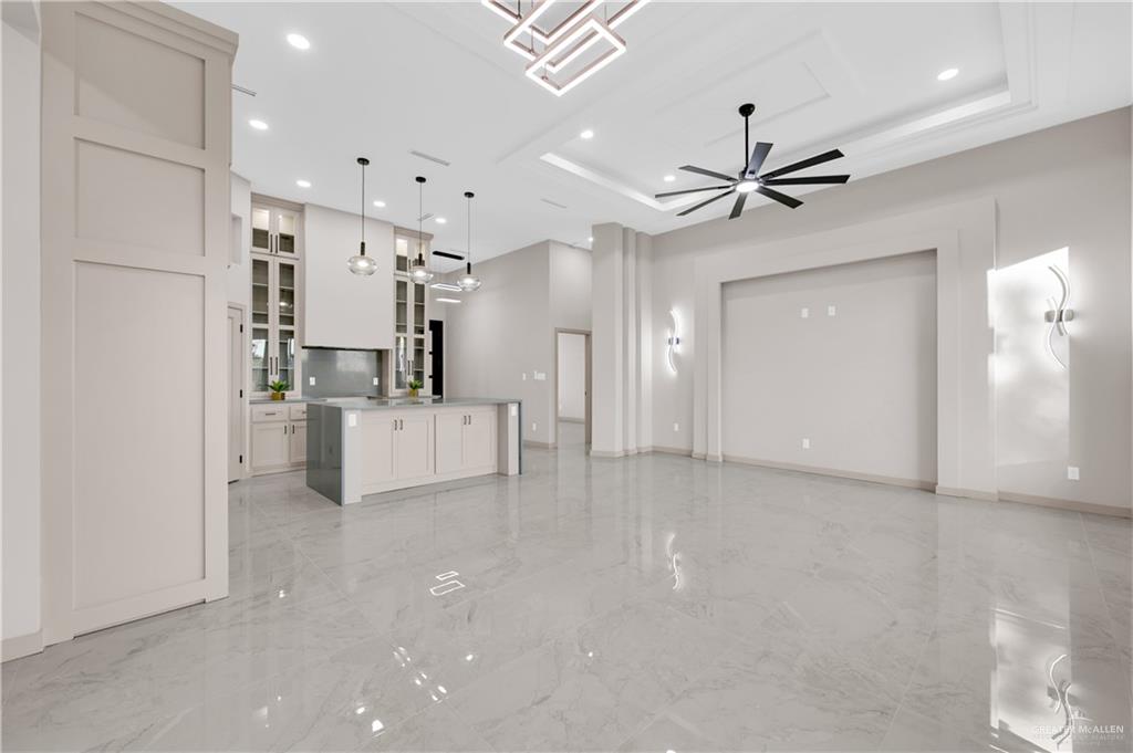 608 Spring Drive Alton, TX 78573 - Photo 10 of 32 Unfurnished living room featuring light marble finish flooring, a ceiling fan, and recessed lighting