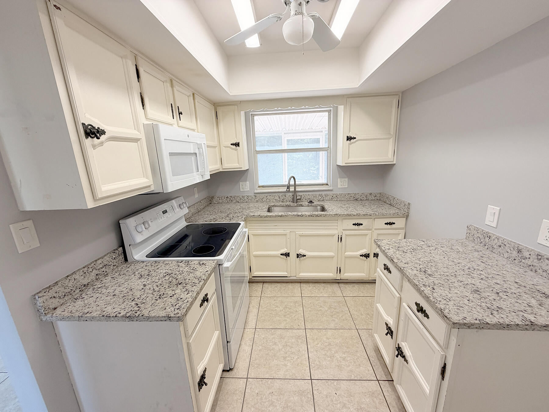 1902 Southeast Gena Road Port St. Lucie, FL 34952 - Photo 9 of 9 a kitchen with a sink stove and cabinets