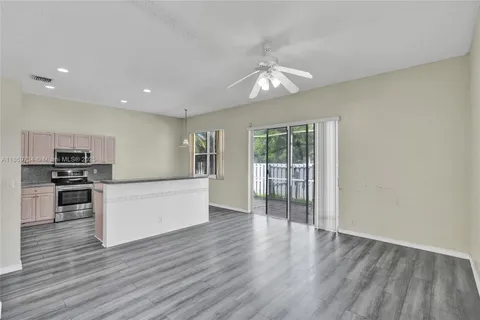 a view of kitchen with sink and wooden floor