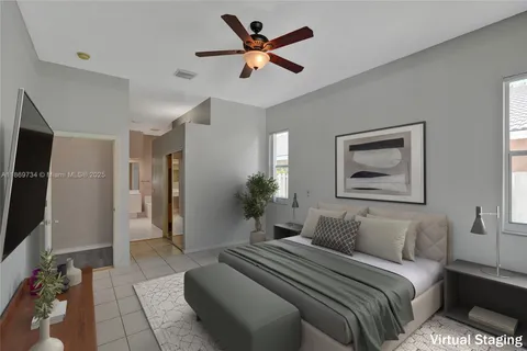 a bedroom with a bed and a painting on the wall