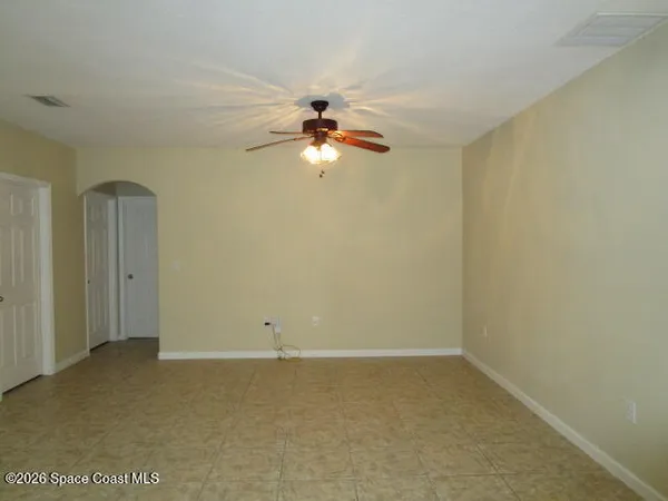 a view of room with a ceiling fan and window