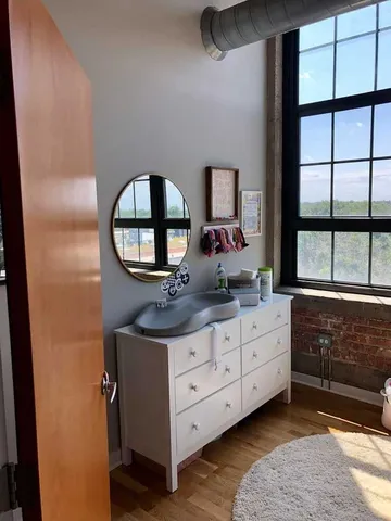 a bathroom with a double vanity sink and a mirror
