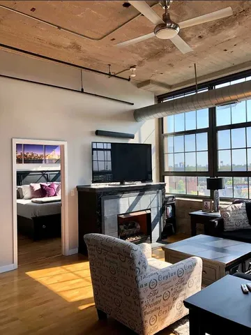 a living room with fireplace furniture and a flat screen tv